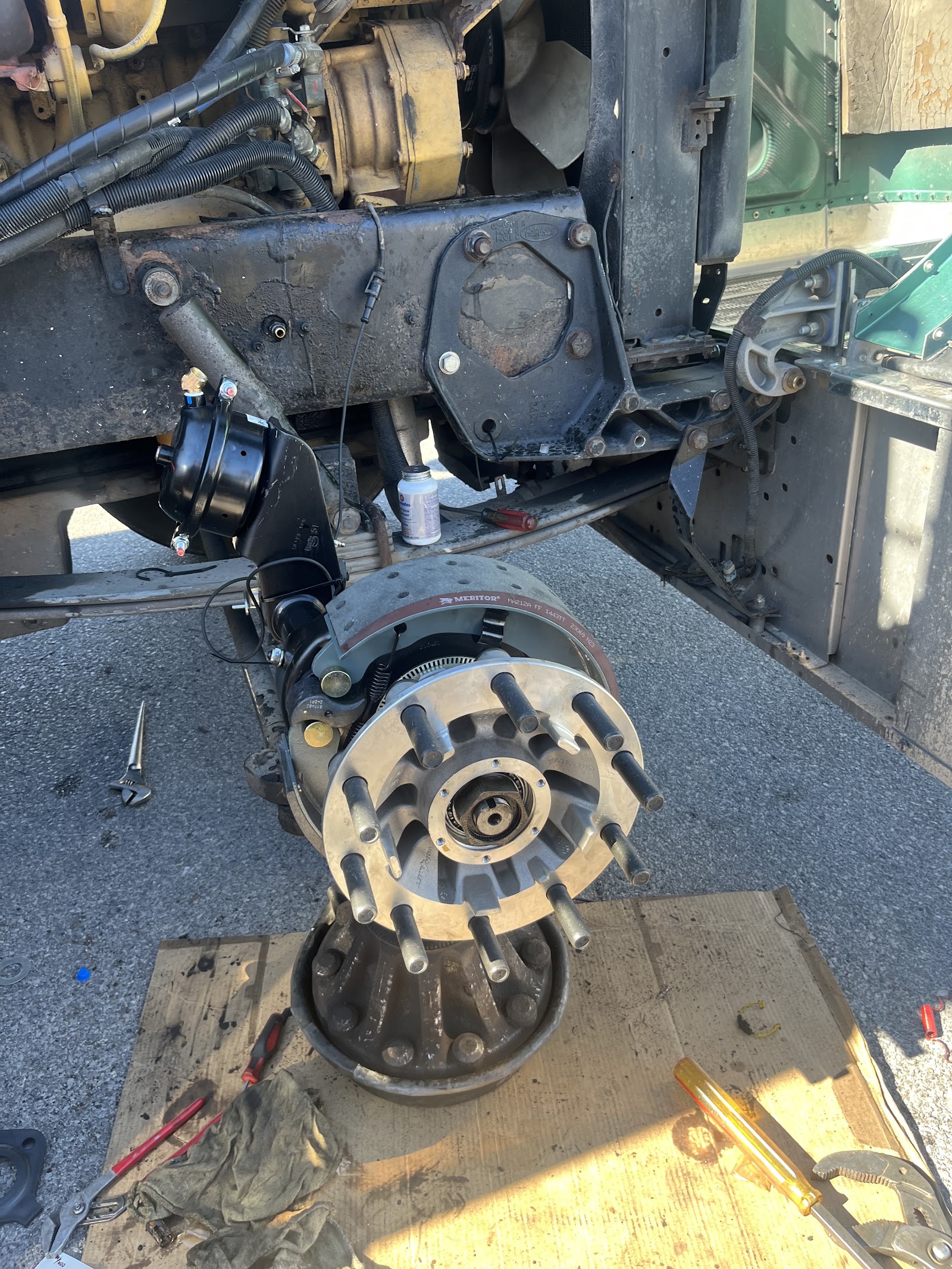 Heavy-duty truck brake and hub assembly disassembled showing Meritor brake drum and wheel hub